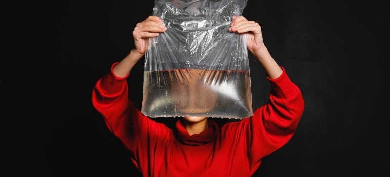 A person holding a bag filled with water  