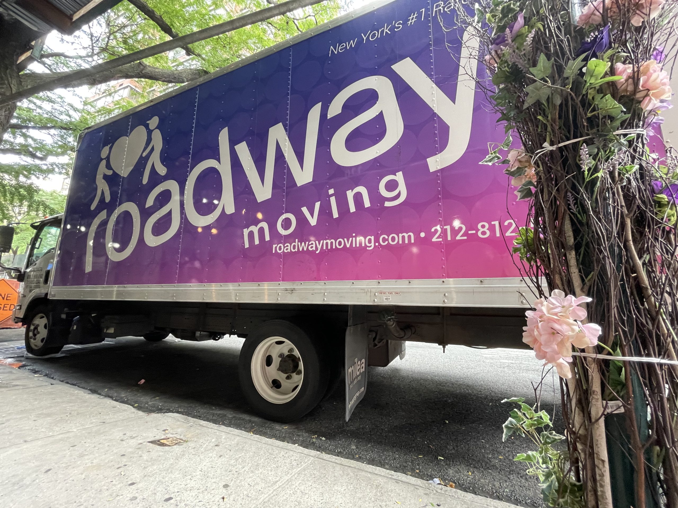 roadway moving truck, representing relocating during peak & non-peak moving season