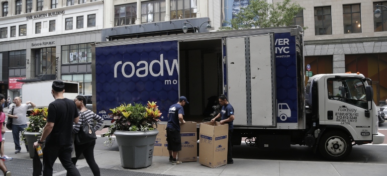 roadway movers loading items into a truck