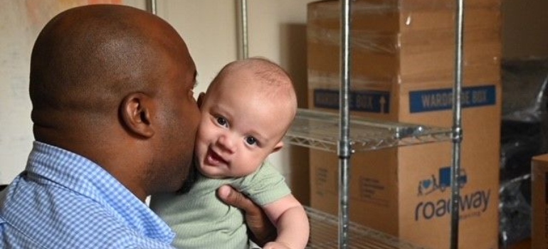 a man kissing a baby