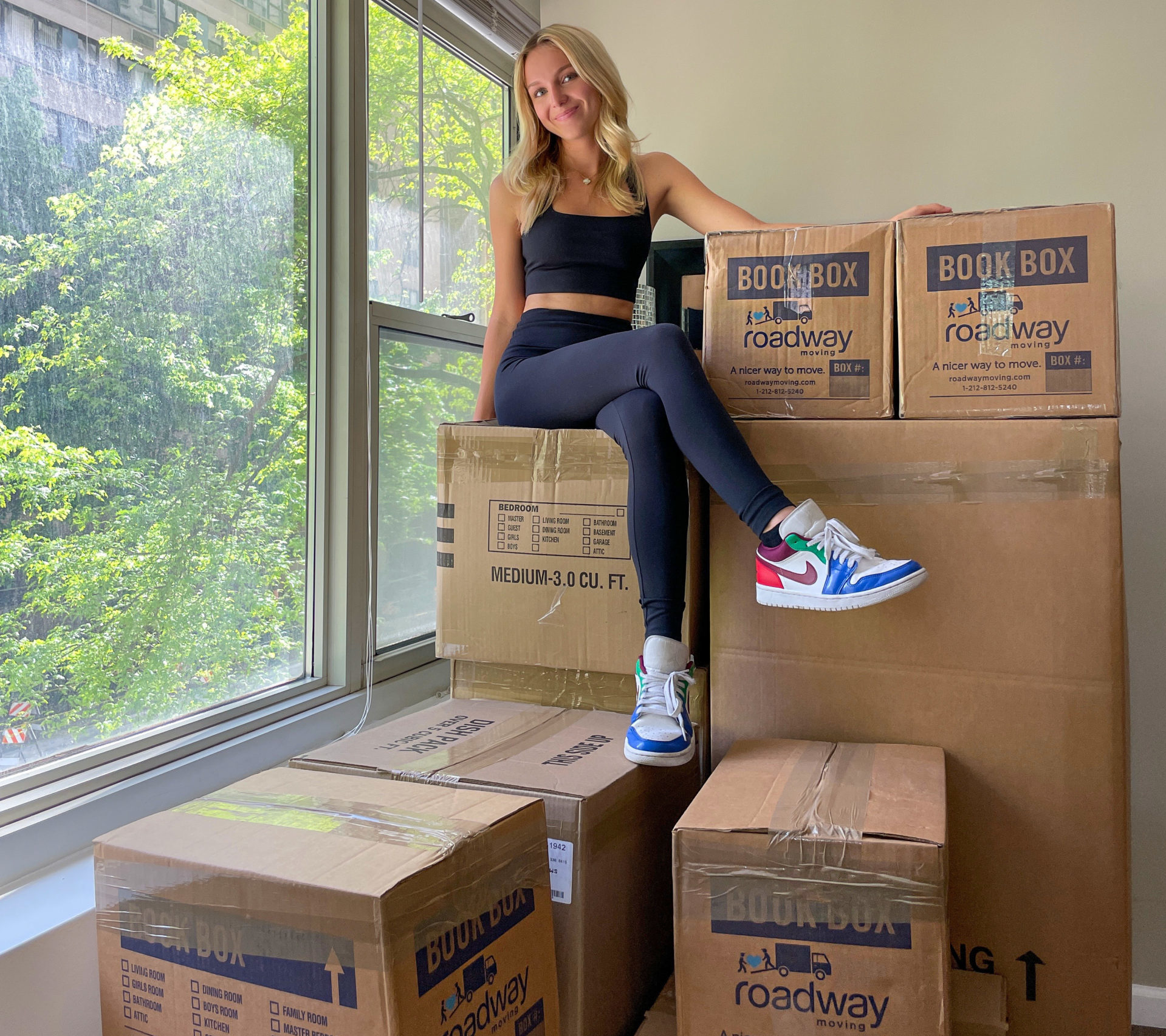 woman sitting on the moving boxes queens