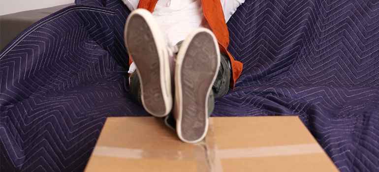 person with their feet on a moving box