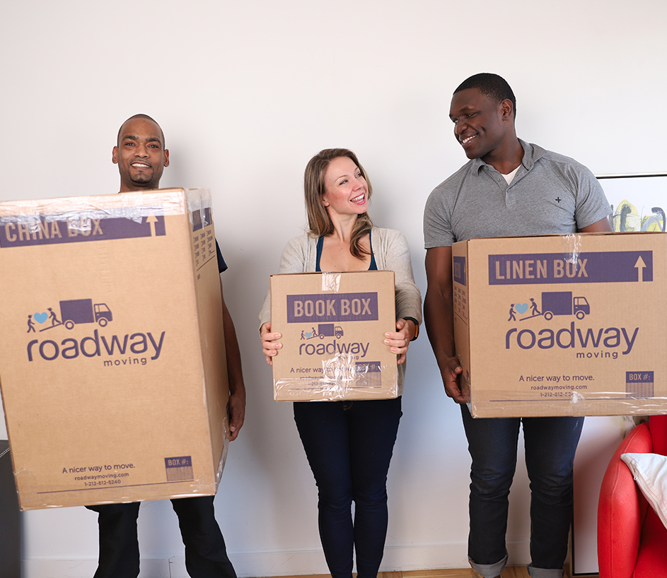 Three people holding boxes