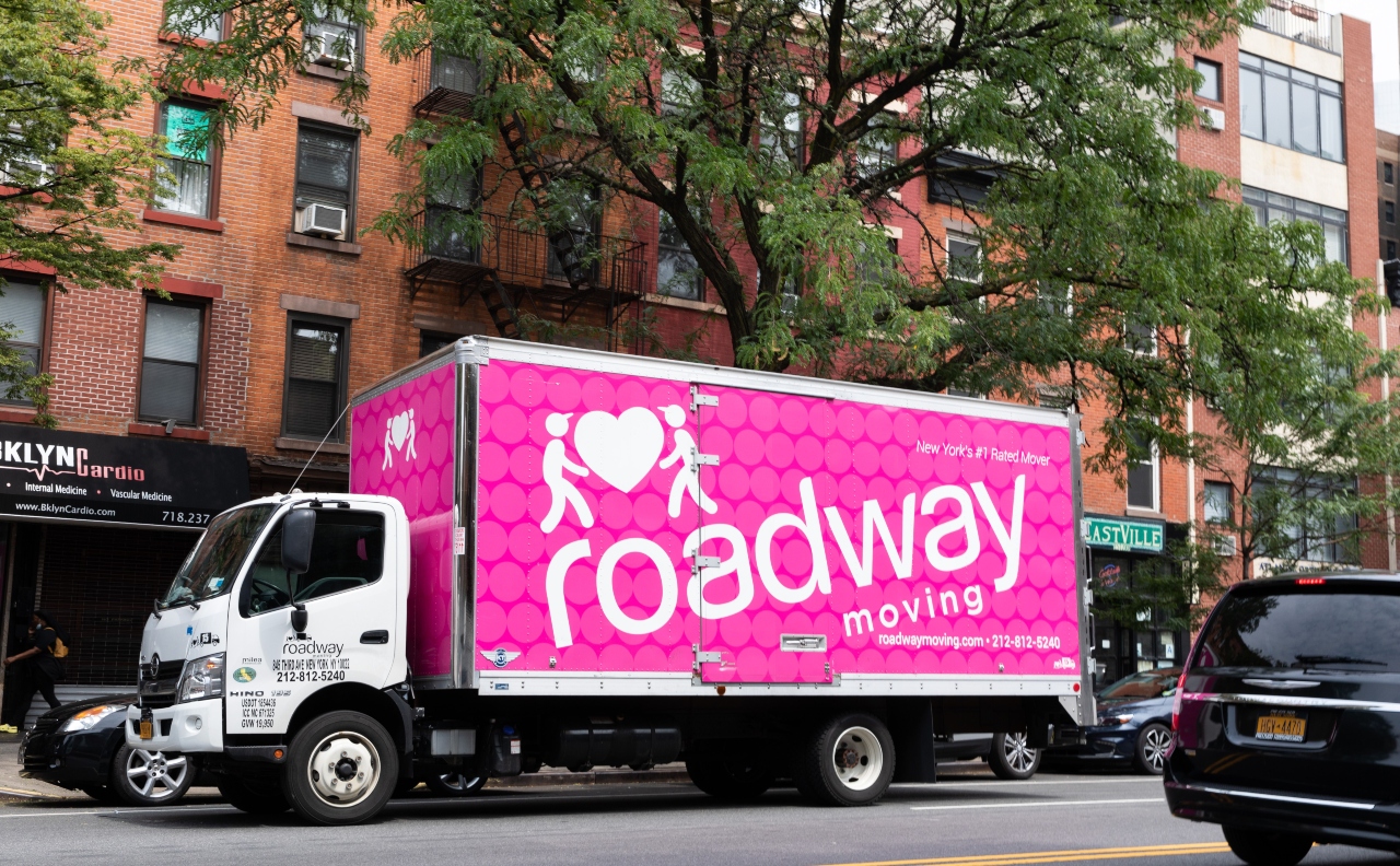 A pink Roadway Moving truck