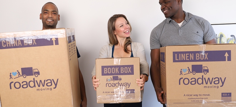 Happy people holding moving boxes because they know how to get ready for moving to Riverdale NY