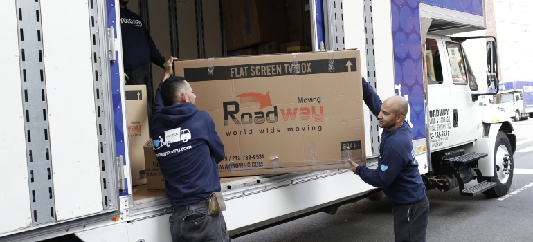 Movers carrying boxes safely which is one of the main benefits of hiring White Glove Movers
