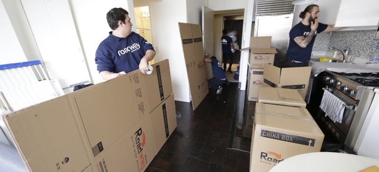 Movers unpacking items in a house
