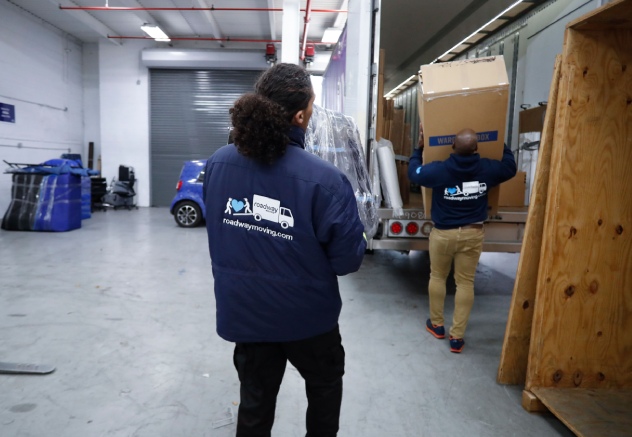 NYC's highest rated office and commercial movers, packing boxes in a moving truck