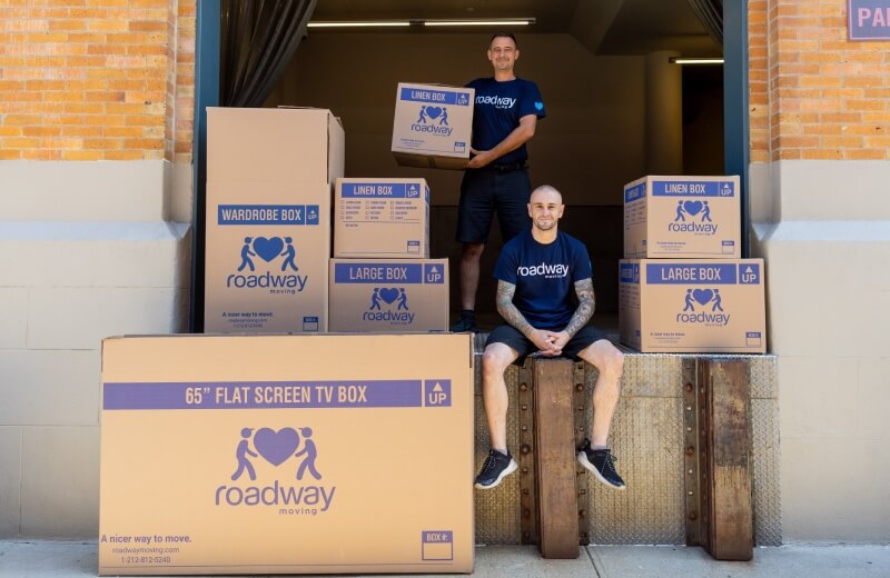 Roadway moving's crew in front of storage