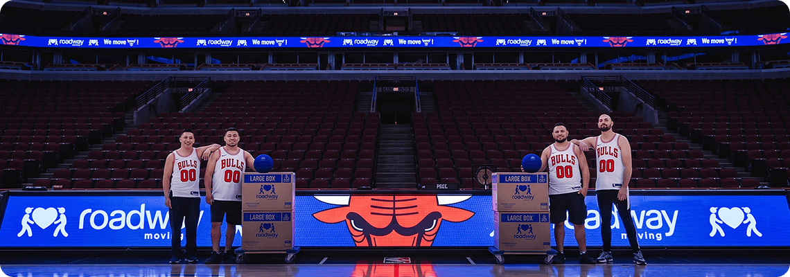 Roadway Moving team courtside at the United Center with branded LED boards