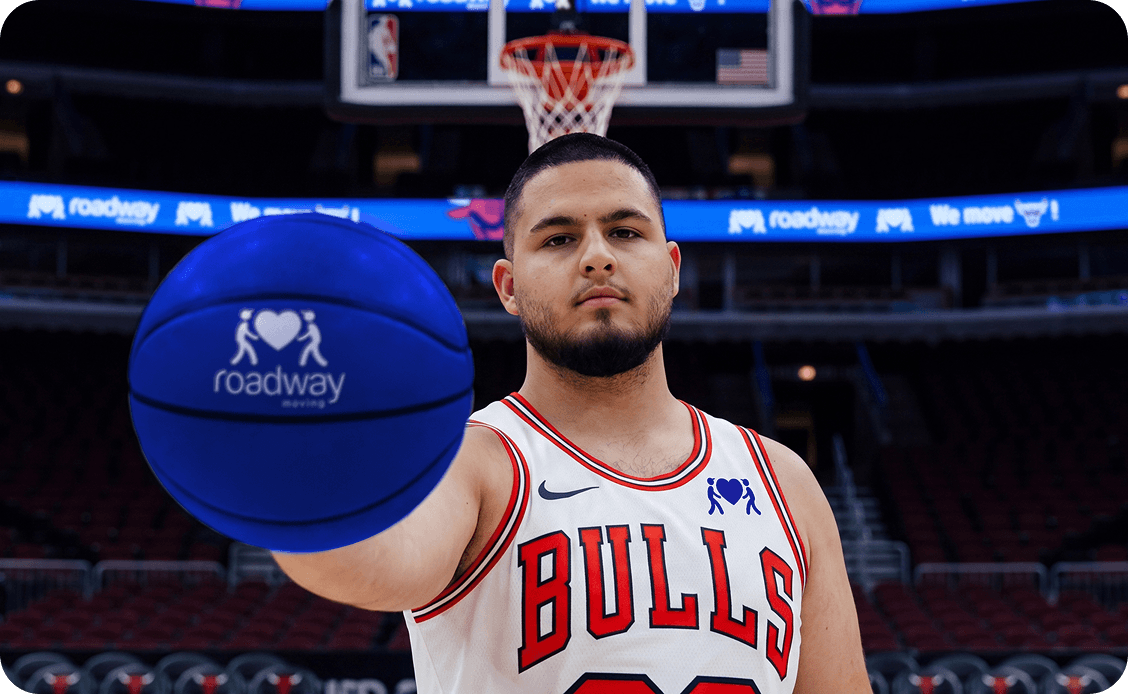 Chicago Bulls player holding a Roadway Moving basketball
