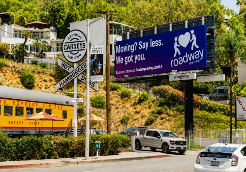 Roadway Moving Billboard next to Carney's Train Car