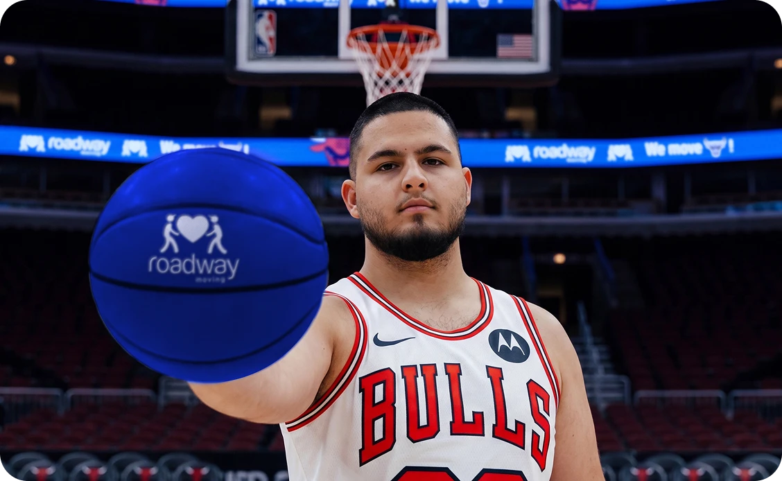 Chicago Bulls player holding a Roadway Moving basketball