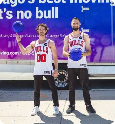 Two movers standing together with a basketball