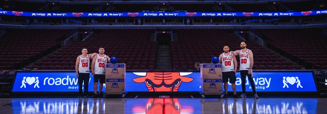Roadway Moving team courtside at the United Center with branded LED boards