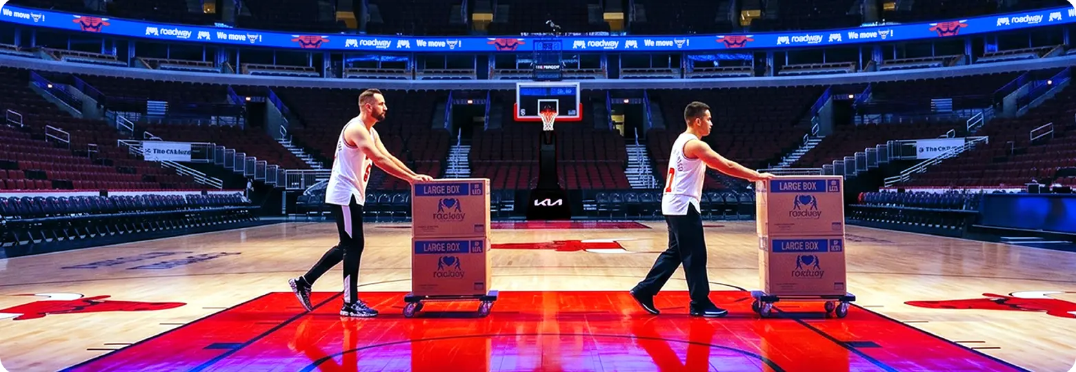 Movers rolling Roadway Moving boxes across the United Center court