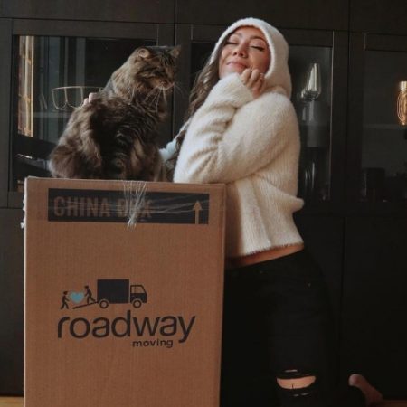 Happy customer with her cat during a move with Roadway Moving